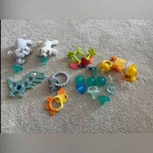 Lot of pacifiers, wubbanubs, teethers and other teething essentials.